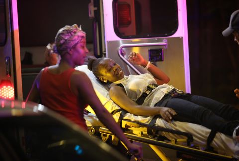 Emergency personnel transport victims from the scene of the shooting on September 19.