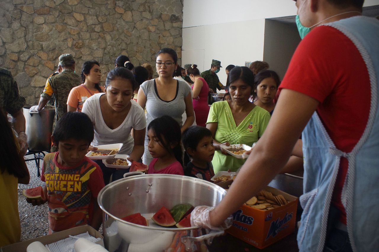 People affected by Hurricane Ingrid and Tropical Storm Manuel wait in shelters set up by the Ministry of Defense on September 19, in Acapulco.