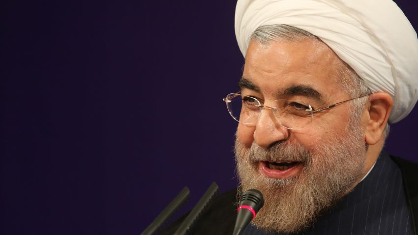 Iran's President Hasan Rowhani smiles as he adresses his first news conference since taking office, in Tehran, on August 6, 2013.