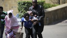 A policeman carries a baby to safety after masked gunmen stormed an upmarket mall and sprayed gunfire on shoppers and staff, killing at least six on September 21, 2013 in Nairobi. The Gunmen have taken at least seven hostages, police and security guards told an AFP reporter at the scene. AFP PHOTO/SIMON MAINA        (Photo credit should read SIMON MAINA/AFP/Getty Images)
