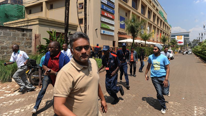 People run away from an upmarket mall after masked gunmen stormed it and sprayed gunfire on shoppers and staff, killing at least six on September 21, 2013 in Nairobi. The Gunmen have taken at least seven hostages, police and security guards told an AFP reporter at the scene. AFP PHOTO/SIMON MAINA        (Photo credit should read SIMON MAINA/AFP/Getty Images)