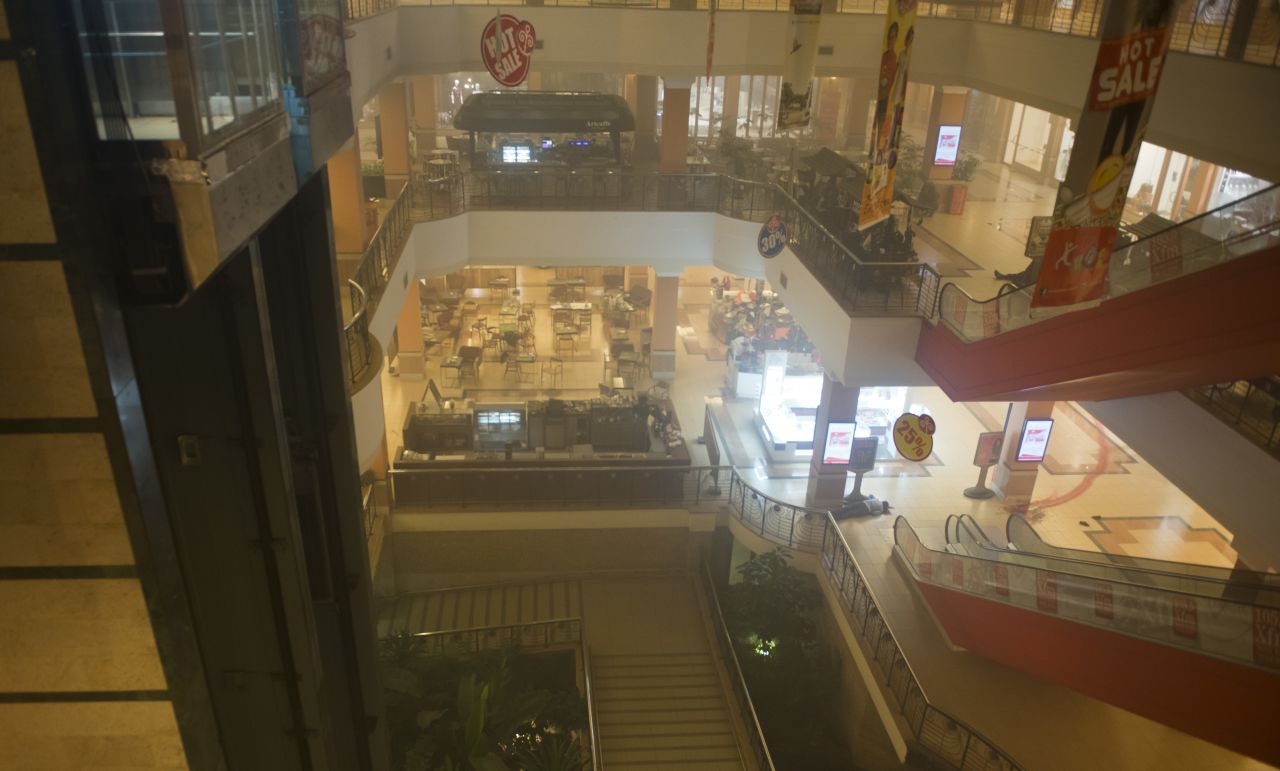 A body is seen on the floor inside the smoke-filled four-story mall.