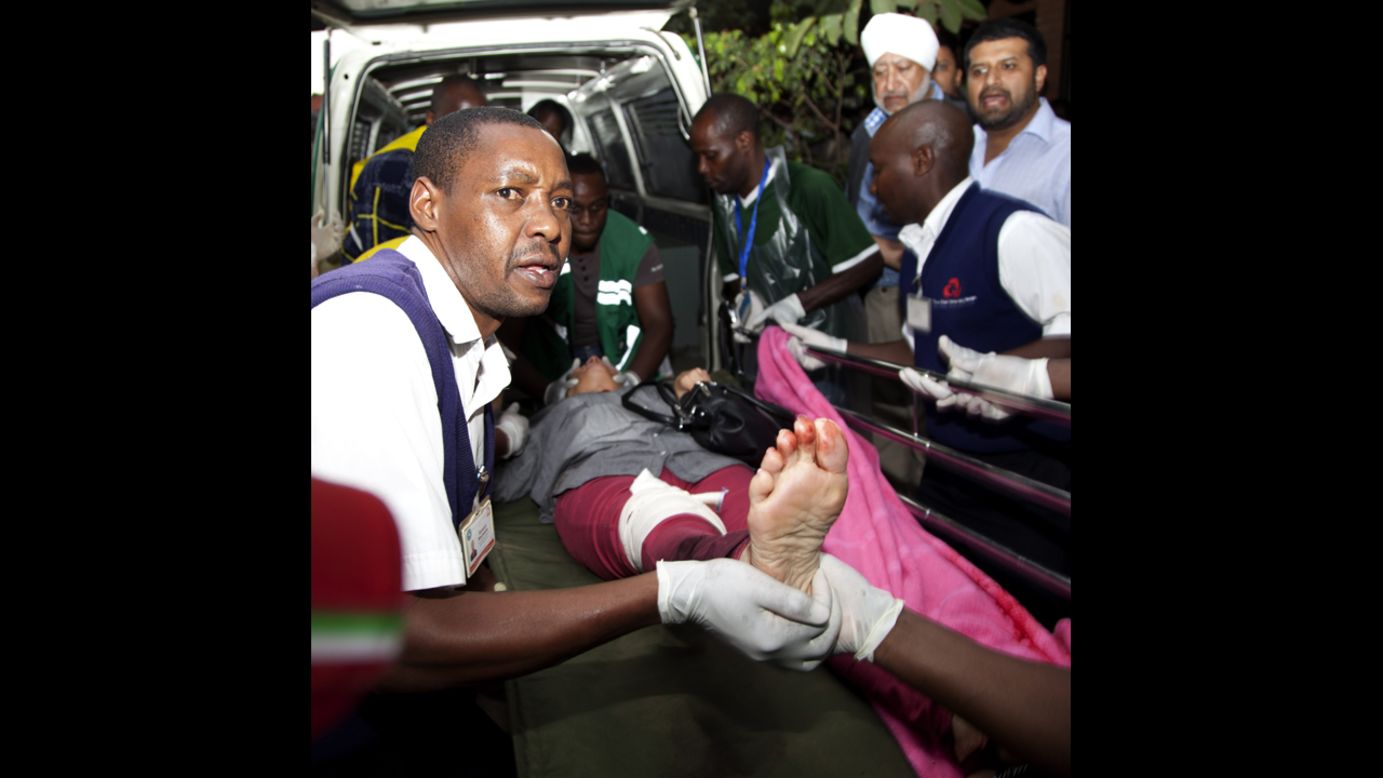An injured person is helped on arrival at the Aga Khan Hospital in Nairobi after the attack at the upscale mall. 