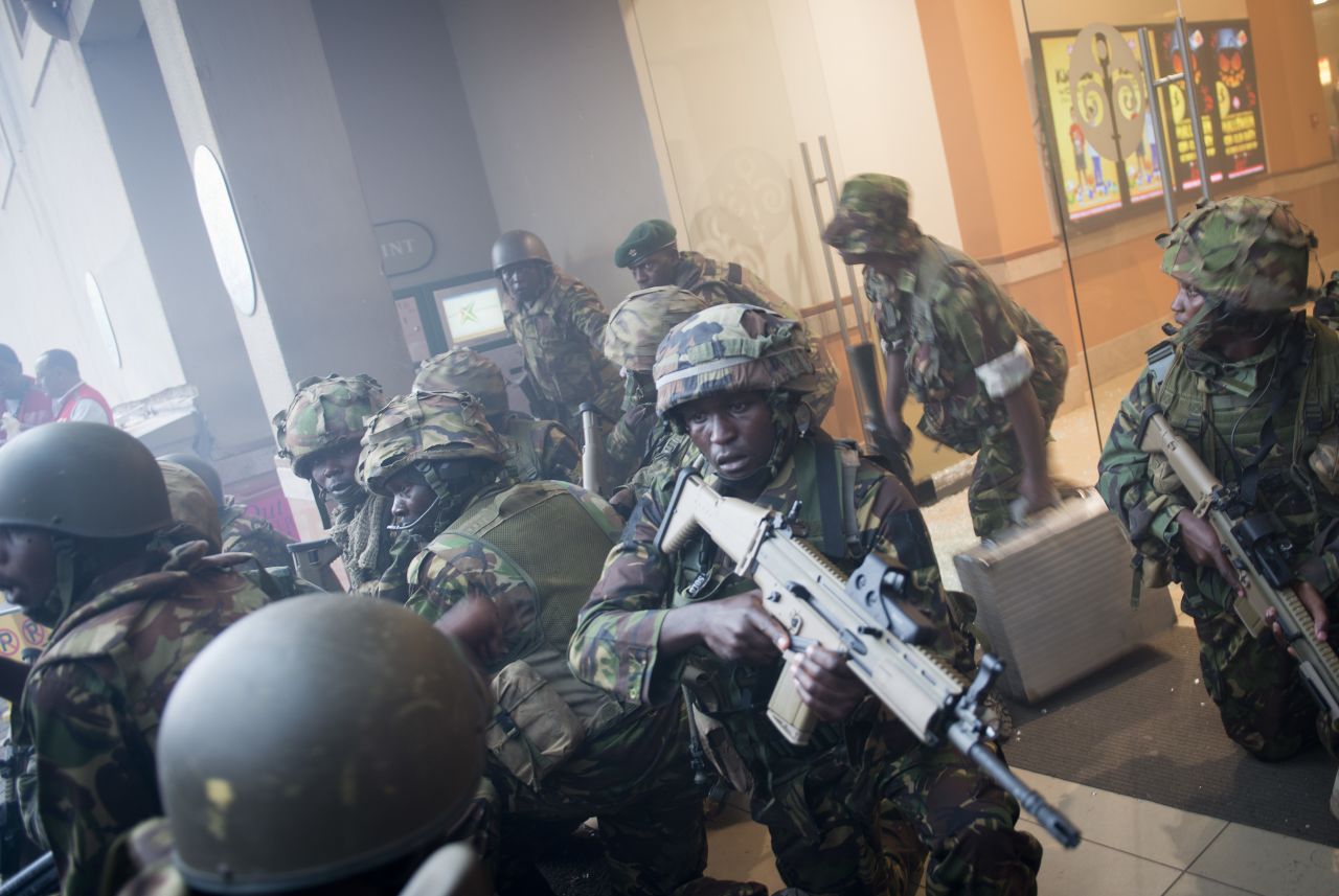 Armed police leave after entering the mall. At least one suspect has been killed, a government official said. Police have said another suspected gunman has been detained at a Nairobi hospital.