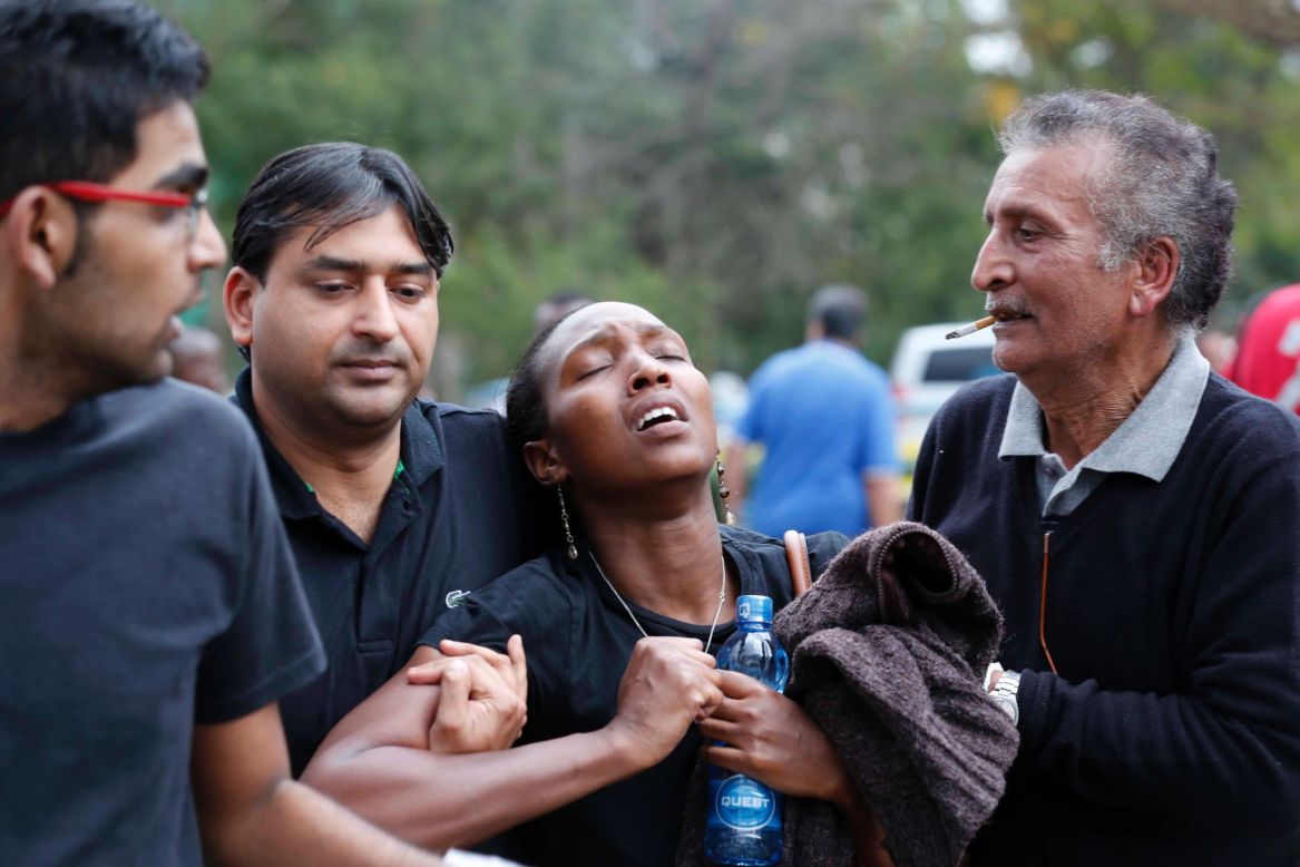 A woman reacts after she is rescued from the mall. 