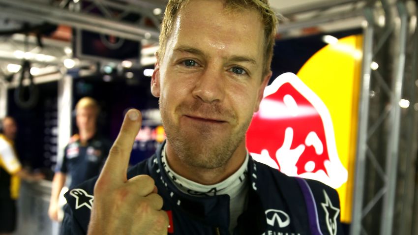 Sebastian Vettel of Germany and Red Bull Racing celebrates after qualifying on Pole Position for the Singapore Formula One Grand Prix at Marina Bay Street Circuit on September 21, 2013 in Singapore, Singapore. (Photo by Mark Thompson/Getty Images