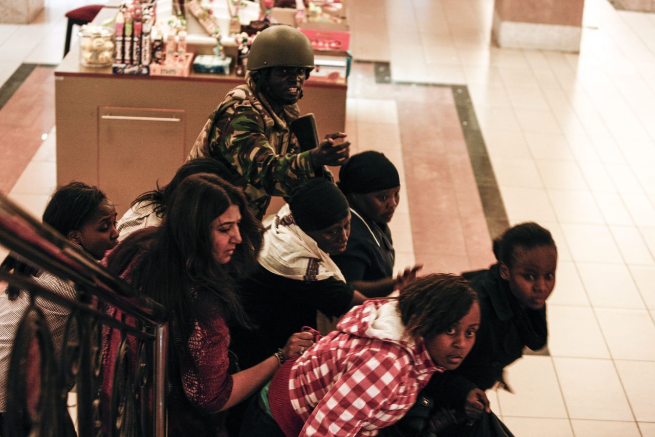 A soldier directs people up a stairway inside the Westgate on September 21.