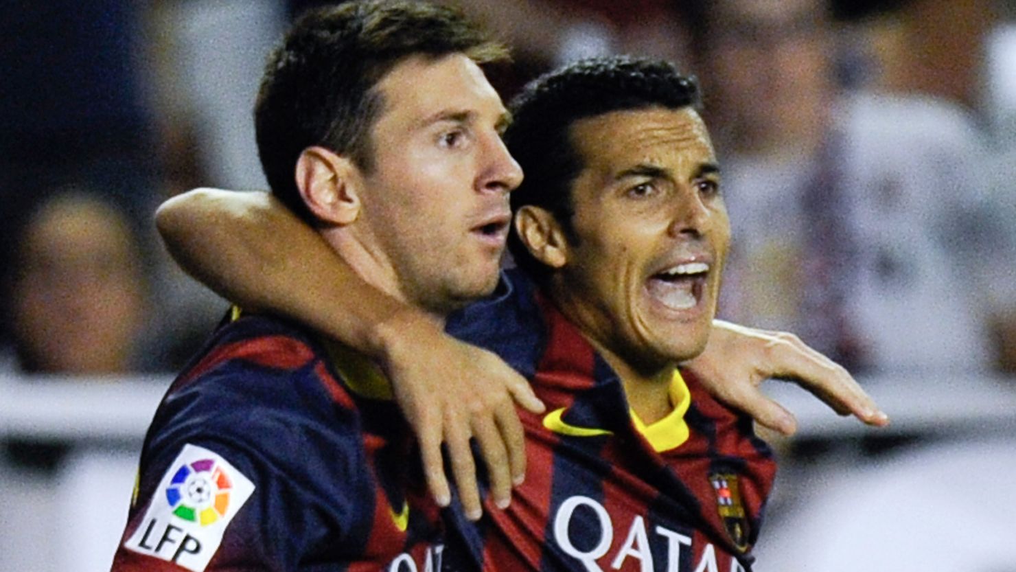 Barcelona's hat-trick hero Pedro Rodriguez (R) celebrates with Lionel Messi after scoring the opening goal against Rayo Vallecano.