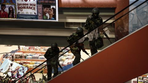 Soldiers move up stairs inside the Westgate Mall.