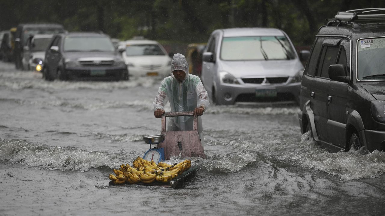 A banana vendor crosses a flooded street in Manila, Philippines, on Sunday, September 22, as monsoon rains from Typhoon Usagi continue to pound the region. Click through to see more photos of weather around the world. 