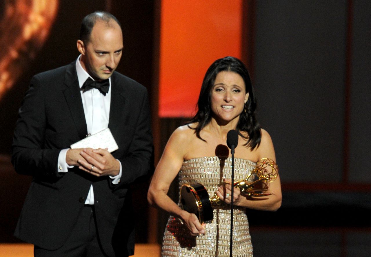 Julia Louis-Dreyfus accepts the award for outstanding lead actress in a comedy series while "Veep" co-star Tony Hale, who won outstanding supporting actor, looks on.