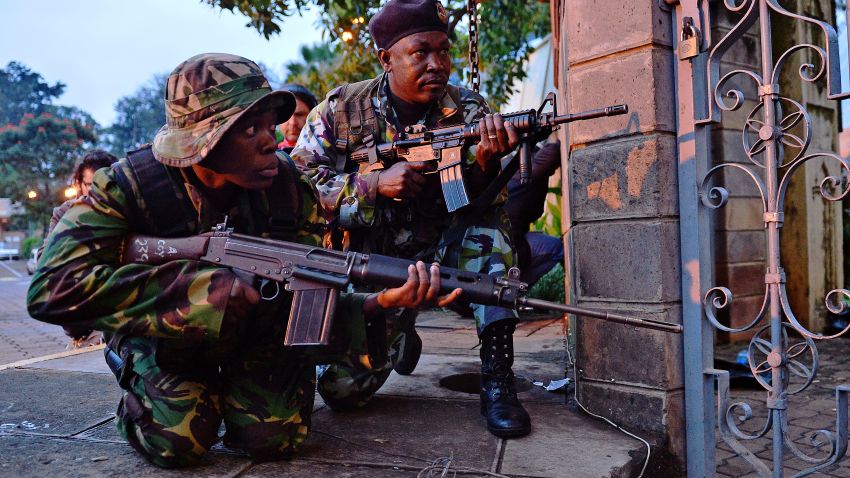 Kenyan soldiers take cover after heavy gunfire near Westgate mall in Nairobi on September 23, 2013.
