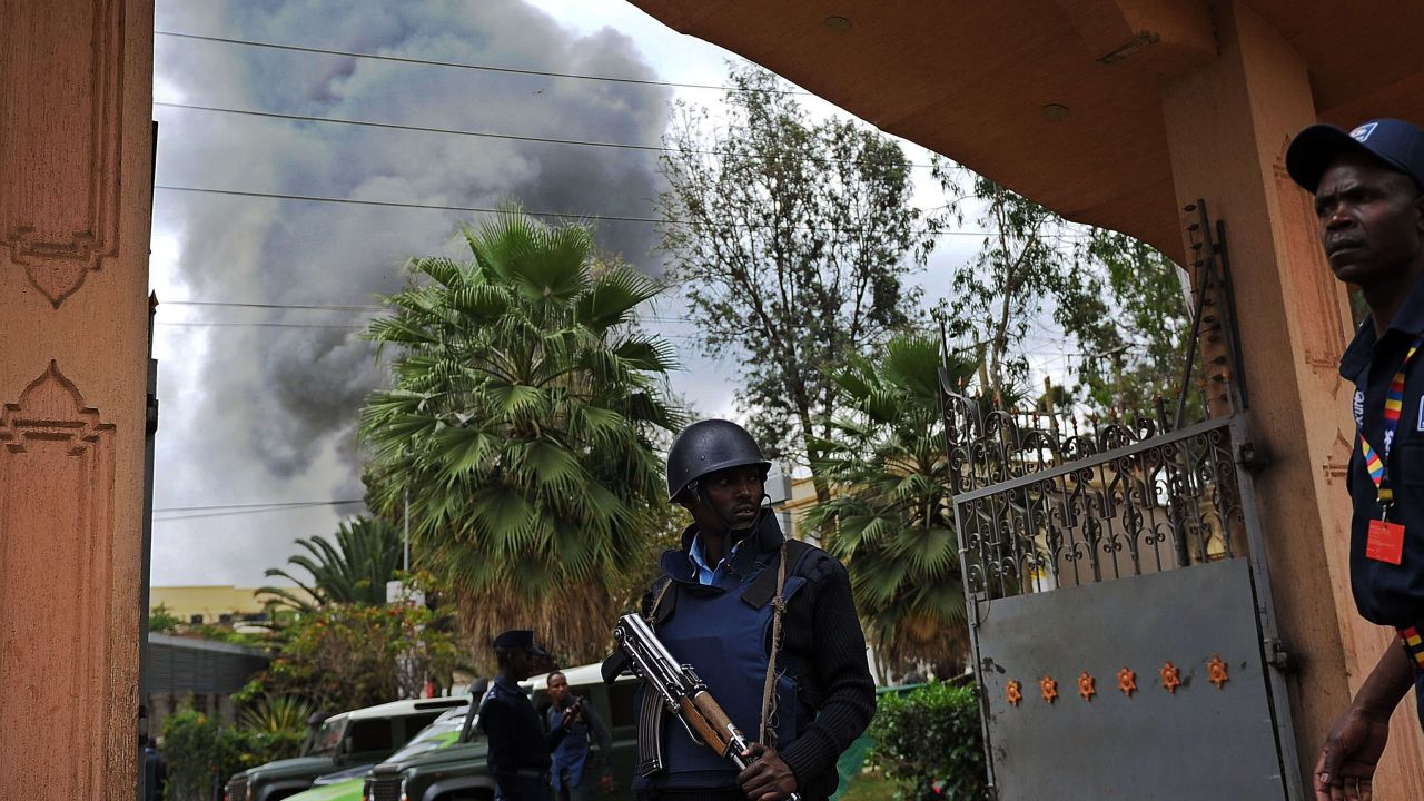 A Kenyan police officer guards the entrance of a building near the mall on September 23.
