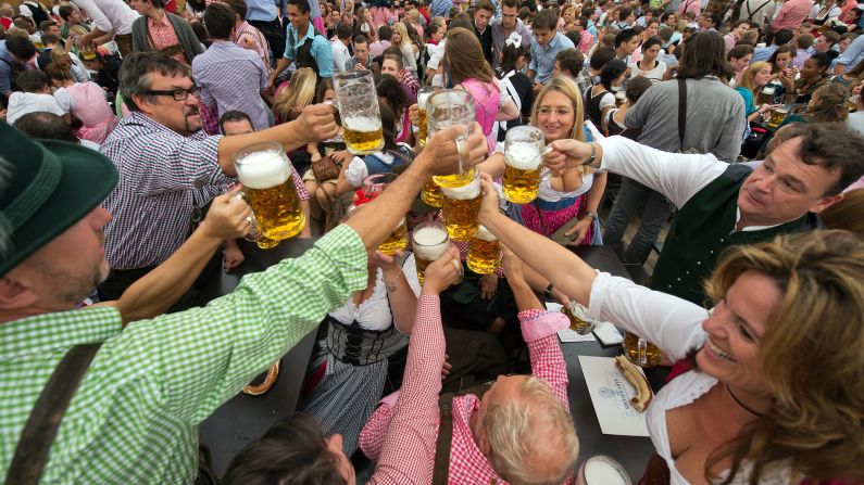 People raise their glasses after getting their first beer of Oktoberfest.