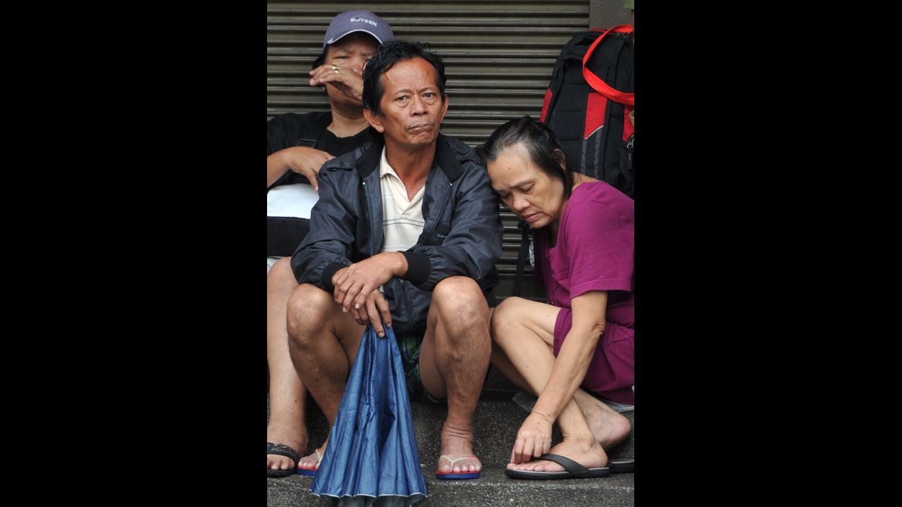 Rescued residents wait for floods to subside after torrential rains pounded the island of Luzon on September 23.