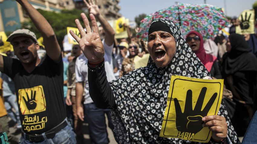 Supporters of ousted Egyptian president Mohamed Morsi raise up posters with the four finger symbol during a demonstration against the military backed government in the Egyptian capital Cairo, on September 13, 2013. Thousands of Morsi supporters rallied in Cairo after Friday prayers chanting angry slogans against the military, with clashes reported elsewhere in Egypt. The four finger symbol, known as 'Rabaa', meaning four in Arabic, is used to remember those killed in the crackdown on the Rabaa al-Adawiya protest camp in Cairo earlier in the year. AFP PHOTO / MAHMOUD KHALED (Photo credit should read MAHMOUD KHALED/AFP/Getty Images)