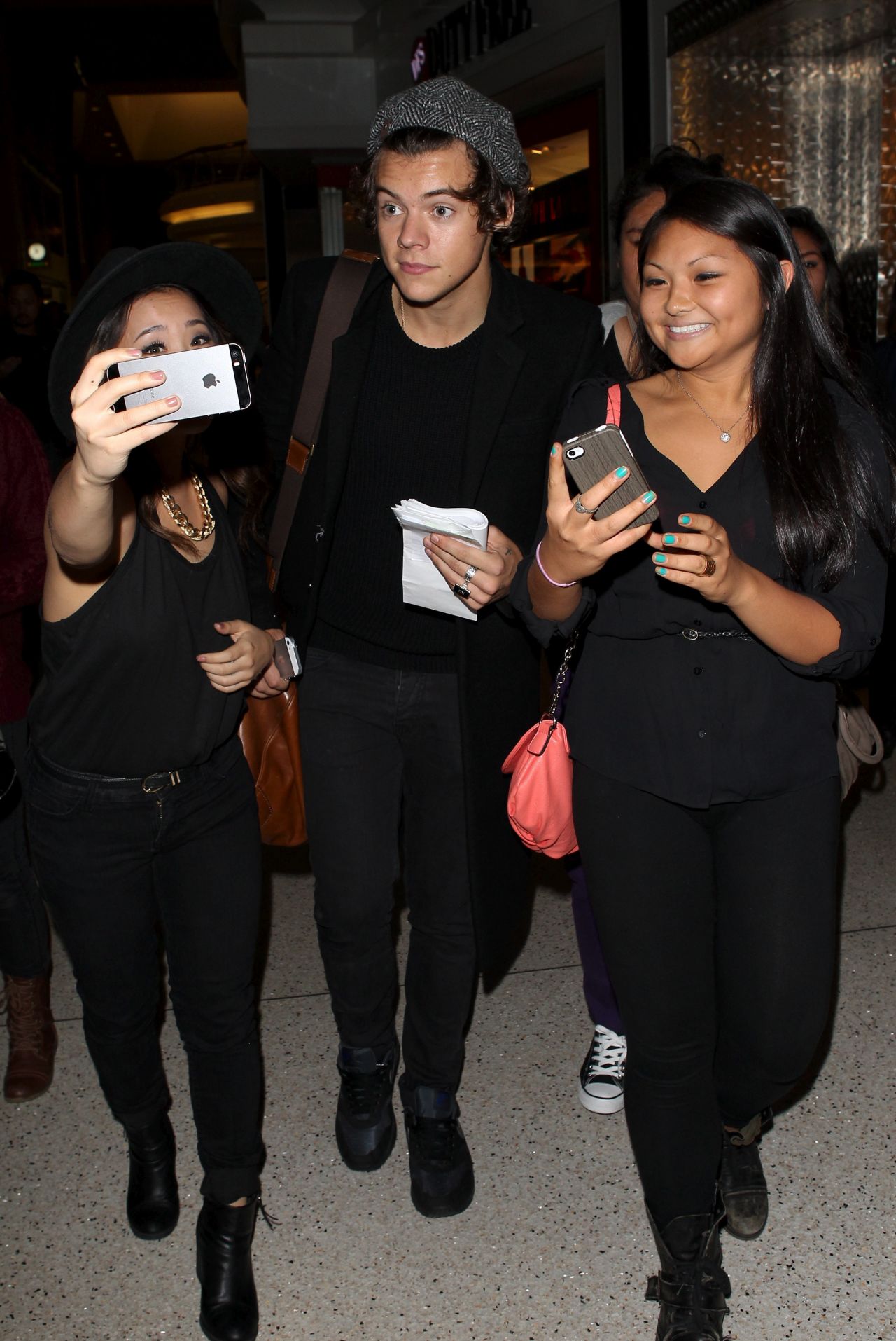 Harry Styles braves One Direction fans while at LAX on September 21.