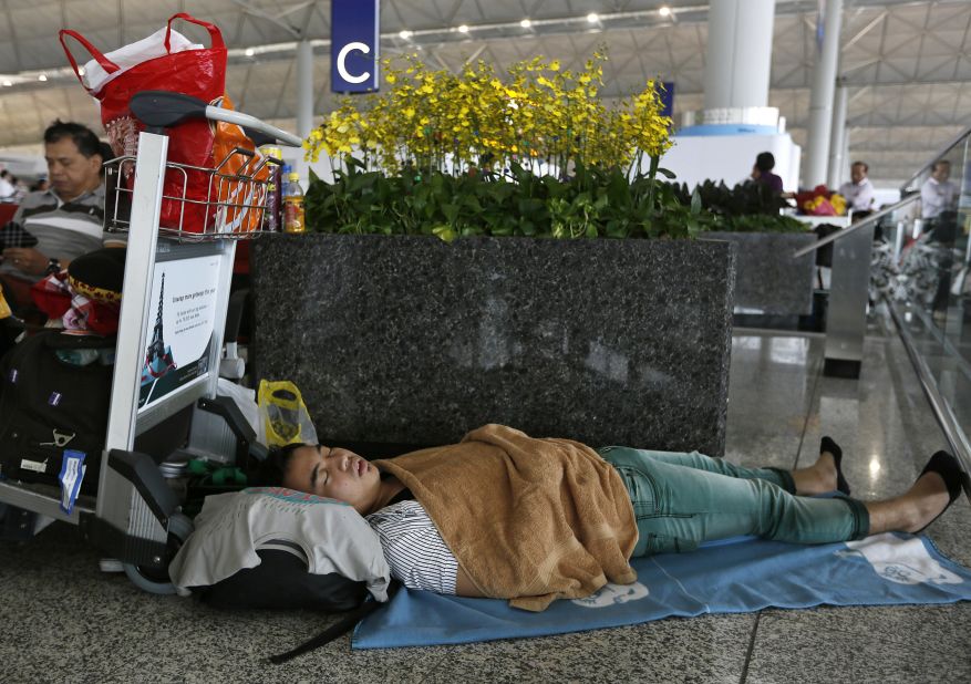 A passenger sleeps at Hong Kong's international airport as flights are delayed on September 23.