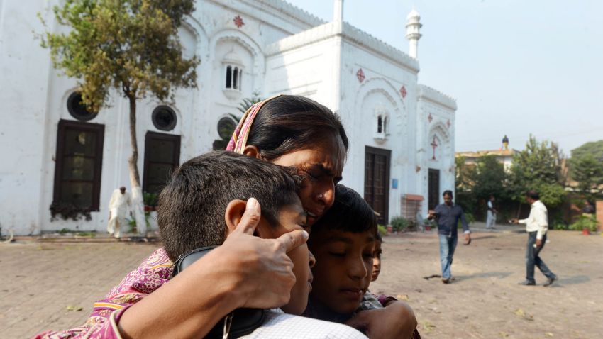 A Pakistani Christian woman embraces children as she mourns the death of relatives at the suicide bombing site at All Saints church in Peshawar on September 23, 2013. The death toll from a double suicide bombing on a church in Pakistan rose to 81, as Christians protested across the country to demand better protection for their community. AFP PHOTO/A MAJEED (Photo credit should read A Majeed/AFP/Getty Images)