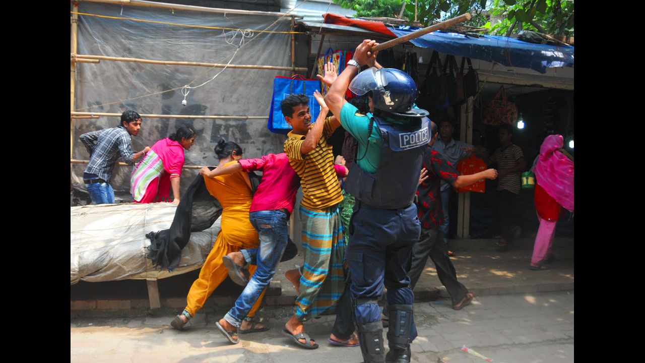 Protesters clash with a police officer in Dhaka, the capital of Bangladesh, on September 23.