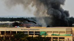 Smoke rises from the Westgate mall in Nairobi on September 23, 2013. Kenyan troops were locked in a fierce firefight with Somali militants inside an upmarket Nairobi shopping mall in a final push to end a siege that has left 43 dead and 200 wounded with an unknown number of hostages still being held. Somalia's Al Qaeda-inspired Shebab rebels said the carnage at the part Israeli-owned complex mall was in retaliation for Kenya's military intervention in Somalia, where African Union troops are battling the Islamists. 