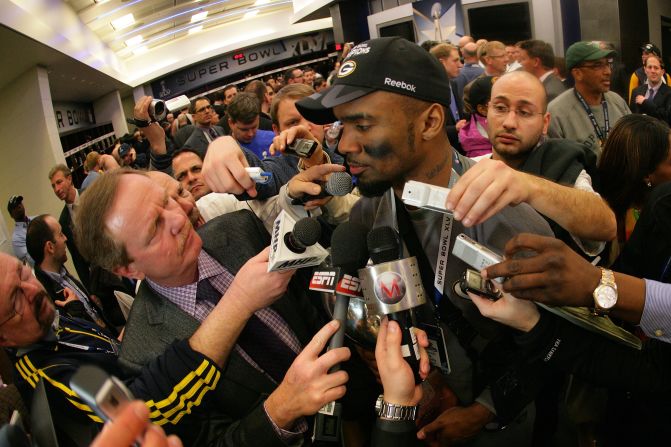 Charles Woodson of the Green Bay Packers fielded questions from a mob of reporters in the locker room after winning Super Bowl XLV at Cowboys Stadium on February 6, 2011 in Arlington, Texas.