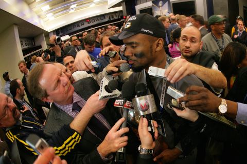 Charles Woodson of the Green Bay Packers fielded questions from a  mob of reporters in the locker room after winning Super Bowl XLV at Cowboys Stadium on February 6, 2011 in Arlington, Texas. 