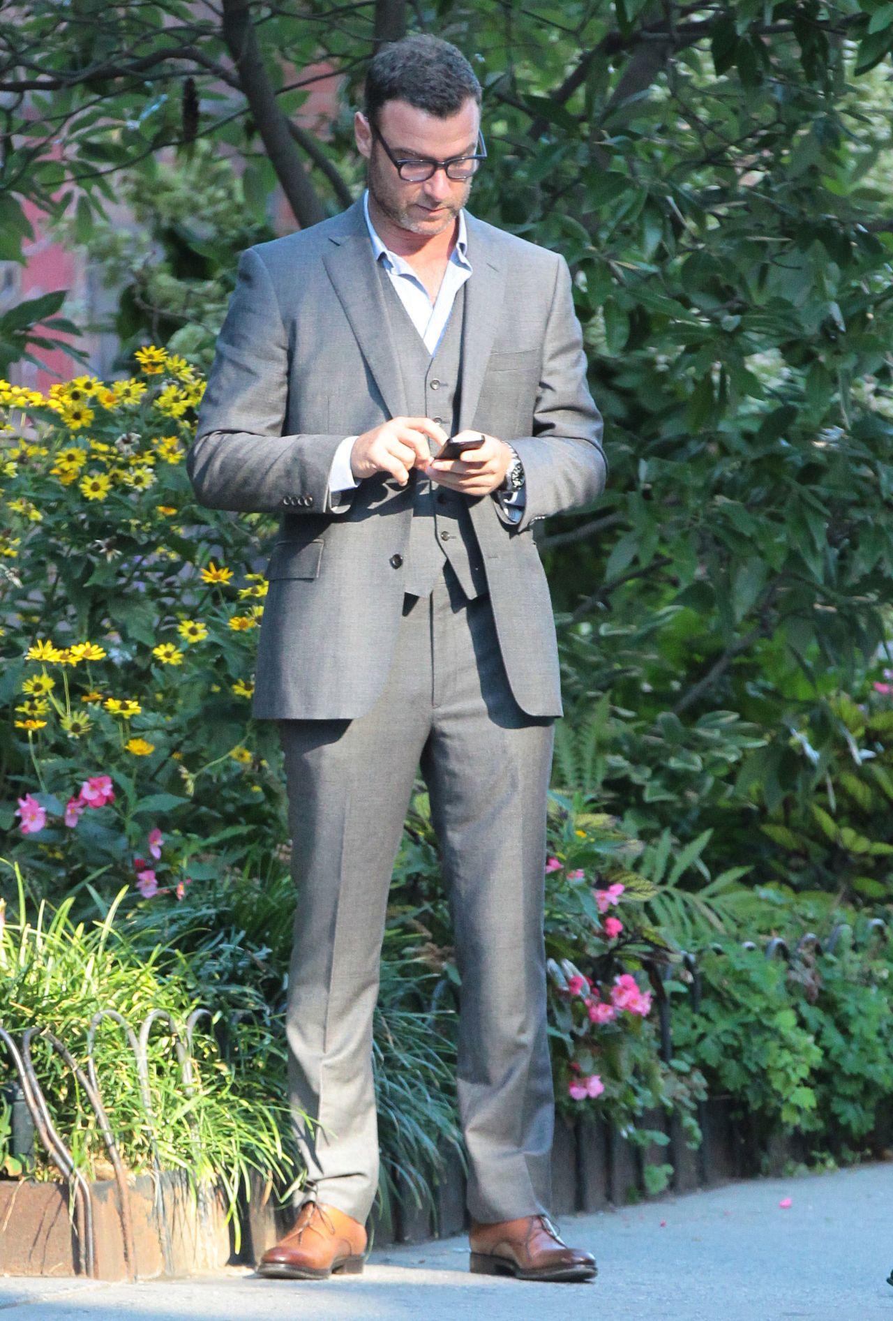 Liev Schreiber does the quick message check while in New York on September 23.