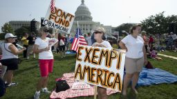 Linda Norman, right, and Joanna Galt, both from Florida, hold their banners during a "Exempt America from Obamacare" rally on the West Lawn of the Capitol in Washington, Tuesday, Sept. 10, 2013. (AP Photo/Manuel Balce Ceneta)