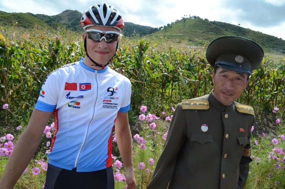 Swedish racer Christian Bertilsson with North Korean police on a countryside road.