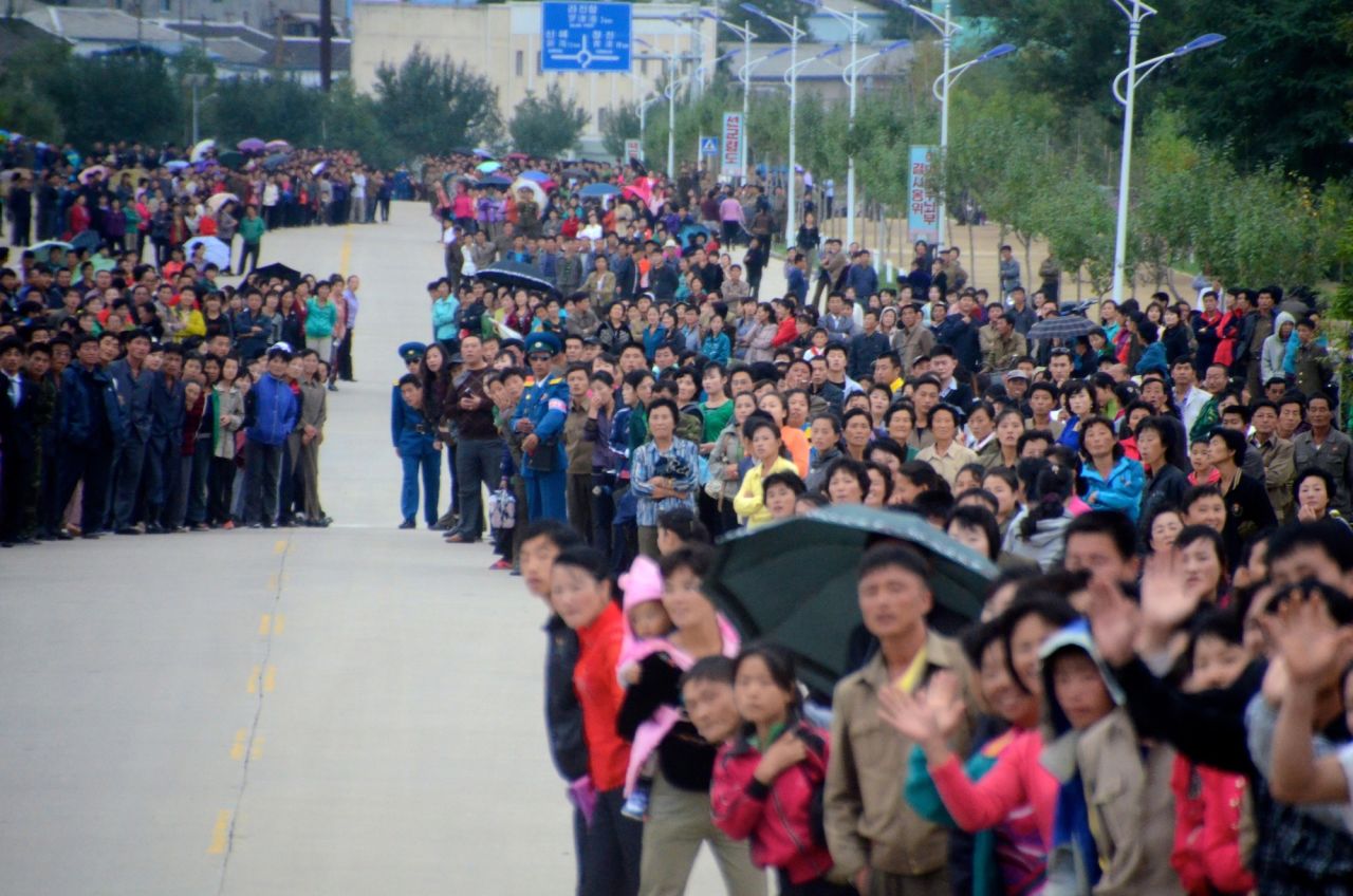 The streets of Rason were lined with thousands of people cheering, waving flags and taking photos with mobile phones.
