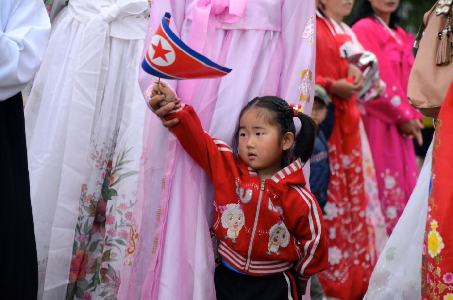 A child with the North Korean flag by the finishing line in Rason.