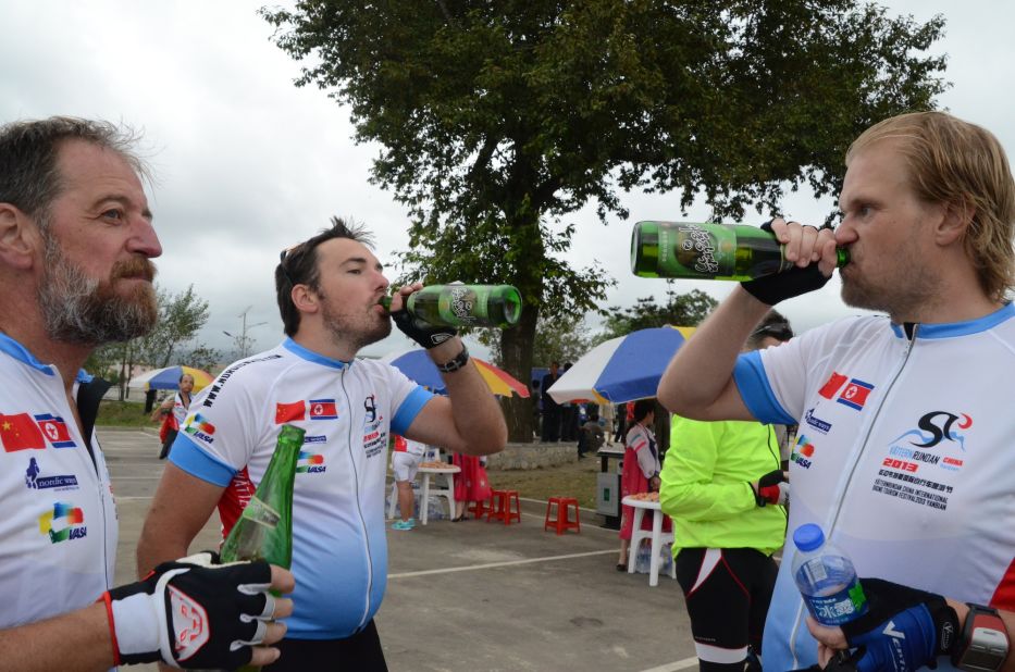 Norwegians and Swedes celebrating with local North Korean beer after reaching the finish line.
