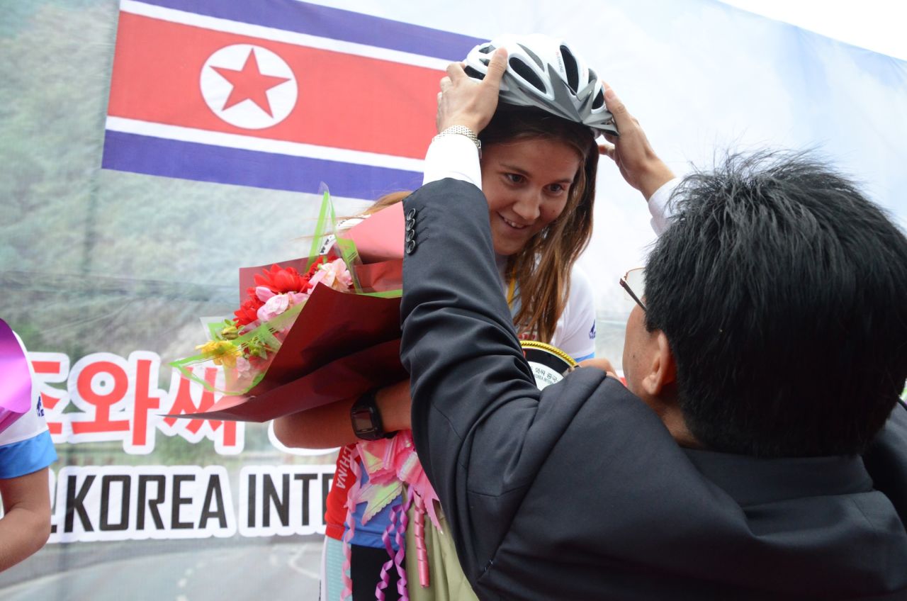 Swedish racer Annie Thorén receives award by Chon Dong Chol, head of the Rason tourism bureau.