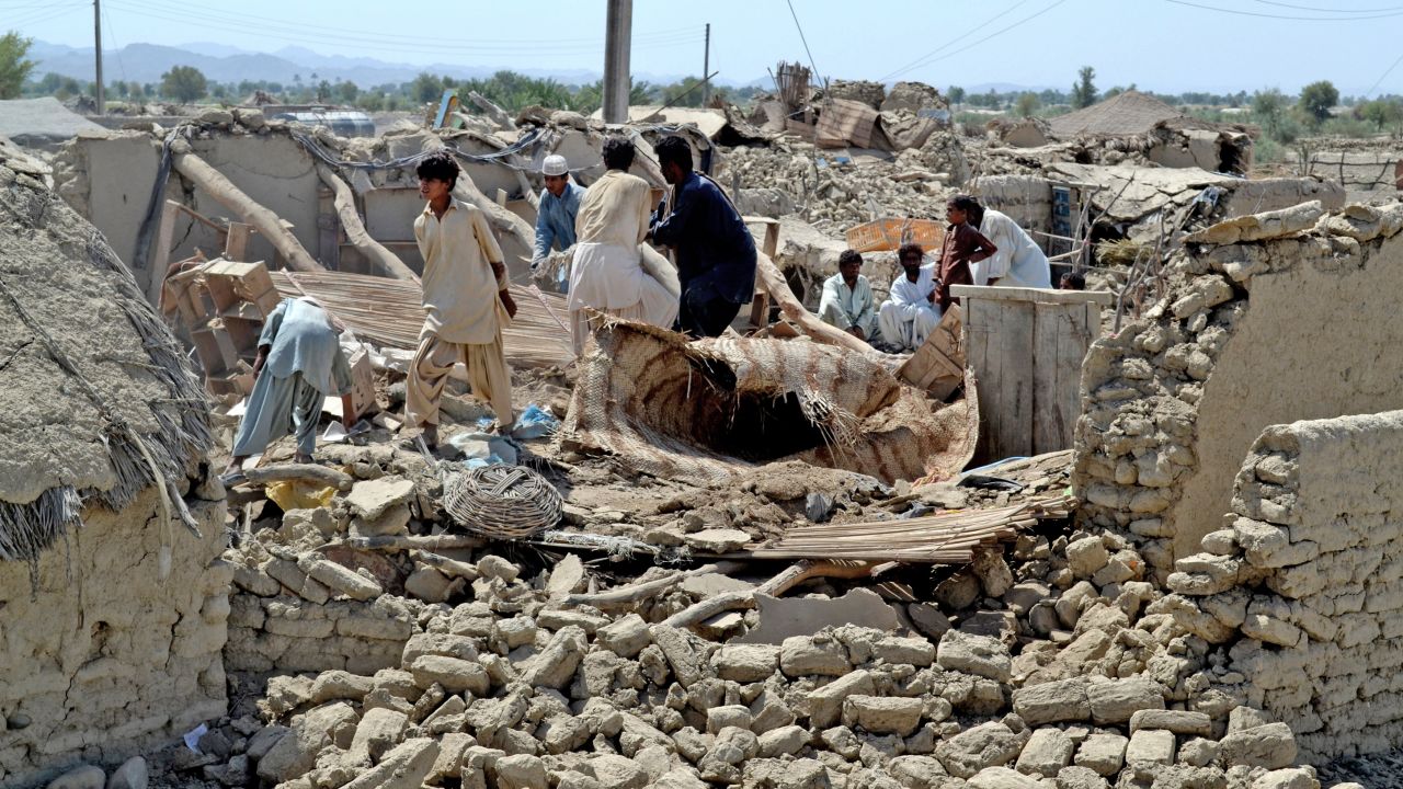 People look for belongings on on September 25, amid the rubble of their destroyed homes after an earthquake.