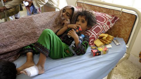 A family rests at a makeshift hospital in Awaran on September 25.