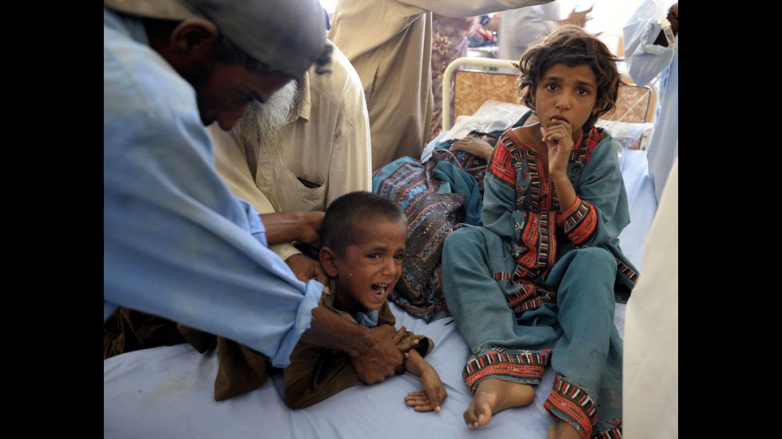 Pakistani children are treated in a makeshift hospital on September 25.