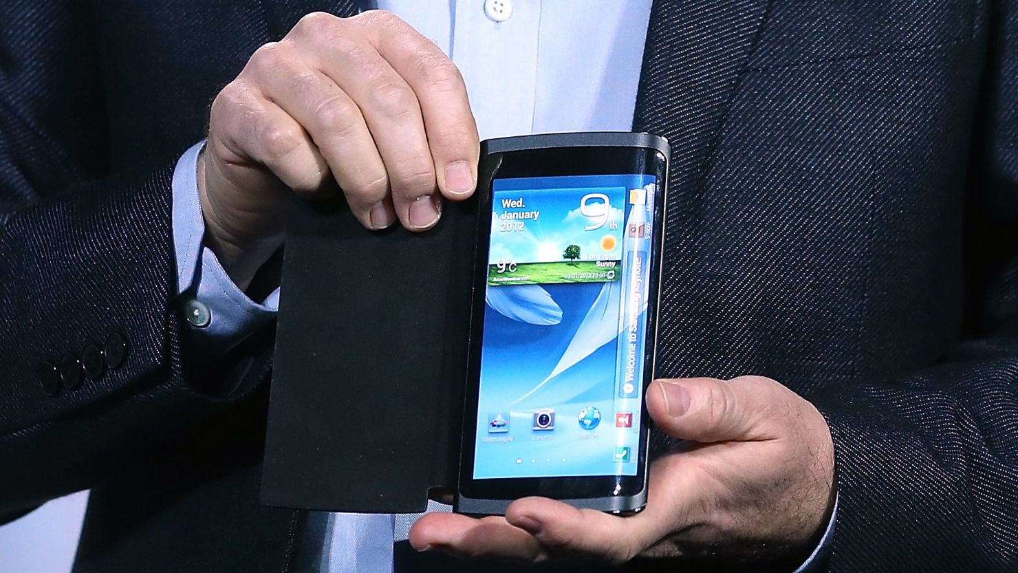 Samsung's Brian Berkeley shows a prototype smartphone with a curved screen at the Consumer Electronics Show in January.
