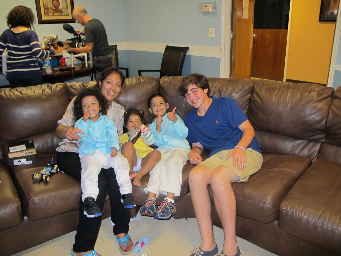 Frencis Velasquez's three children received new shoes from Nicholas Lowinger, right.