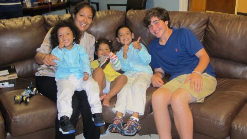 Frencis Velasquez's three children received new shoes from Nicholas Lowinger, right.