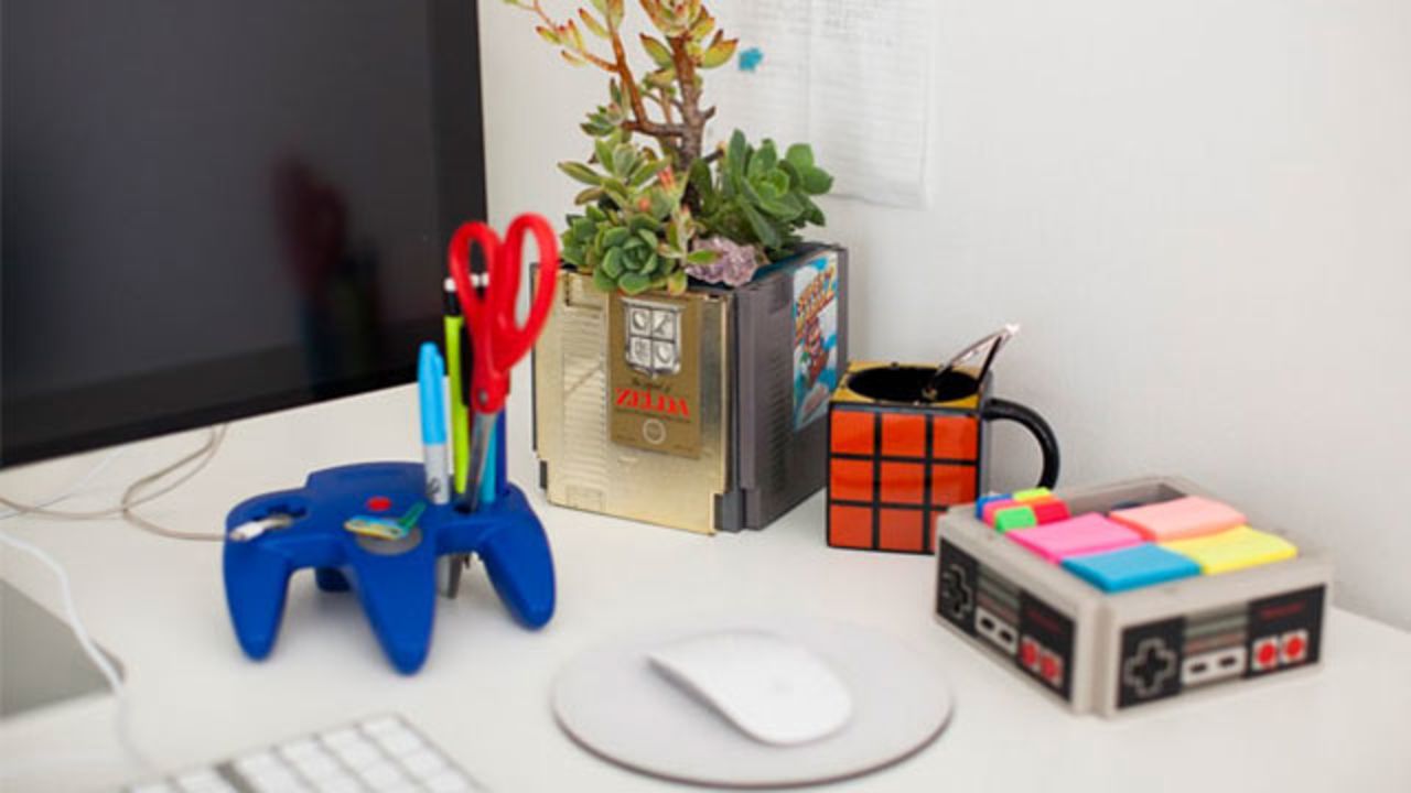 Brit + Co. production manager Misty Spinney created a Nintendo-themed desk, complete with a planter made of classic Nintendo games and a phone charger wired through an N64 controller.