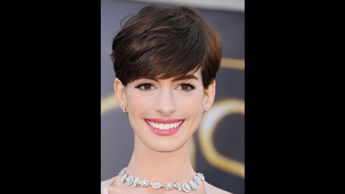 Anne Hathaway's carnation pink lips and subtly defined eyes are perfect for a daytime wedding says makeup artist Kate Lee.