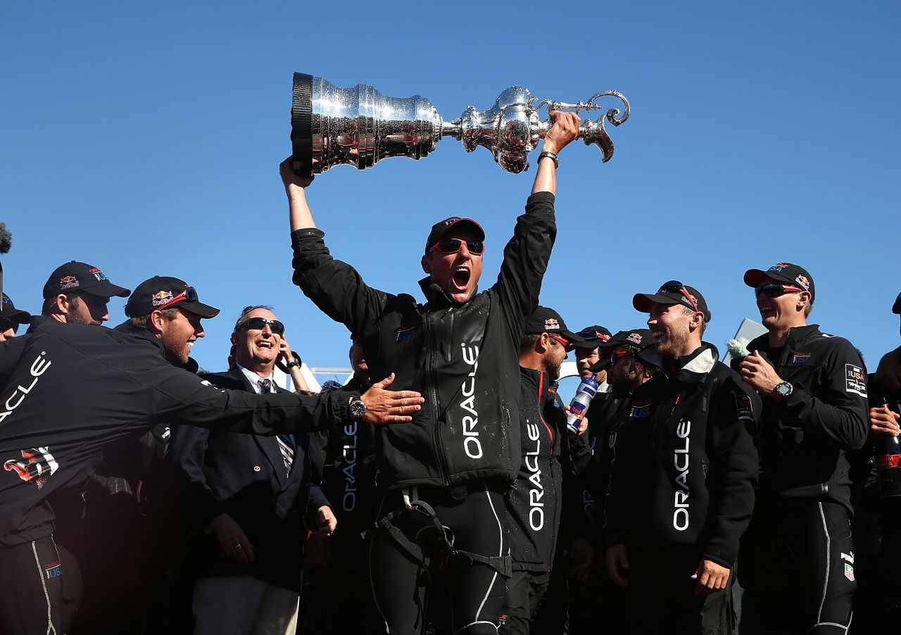 Oracle Team USA skippered by James Spithill celebrates onstage after defending the Cup as they beat Emirates Team New Zealand to defend the America's Cup during the final race on September 25, 2013 in San Francisco, California.