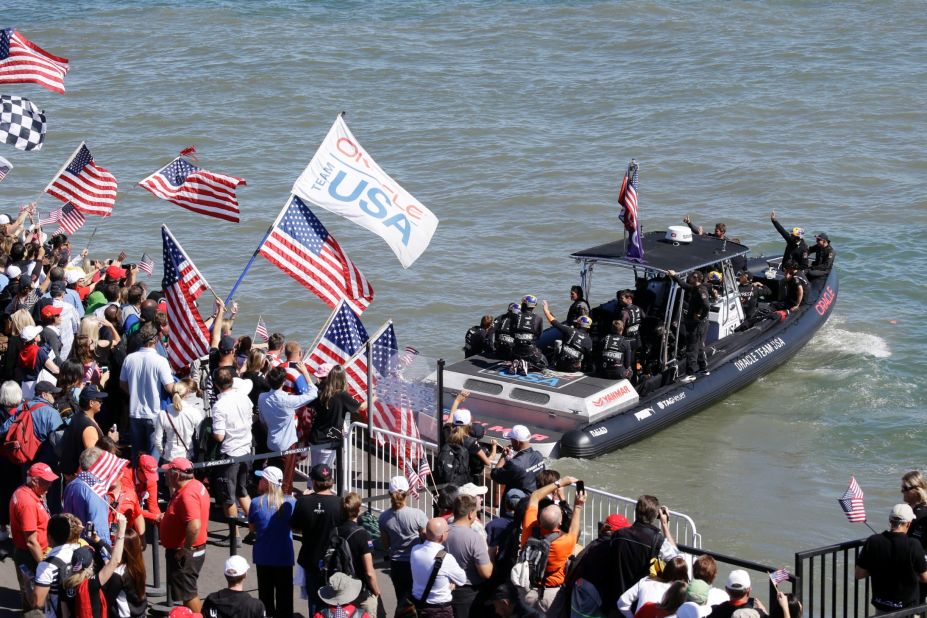 Oracle Team USA was given a huge ovation by the home crowd as its team members boarded the ferry. Supporters flocked to watch with the prospect of history being made.