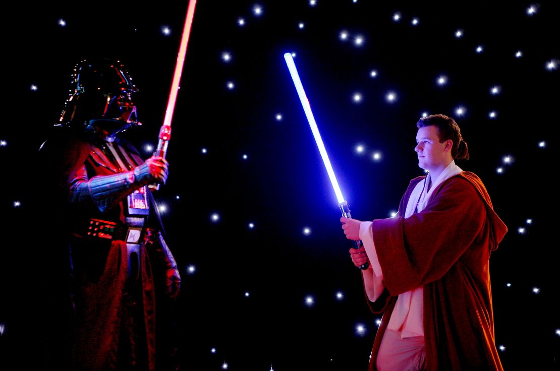  Actors dressed as Darth Vader and Luke Skywalker have a lightsaber battle during an exhibition is Australia.