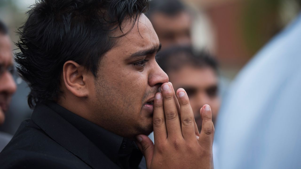 A relative mourns during the funeral service for Selima Merali and Nuriana Merali on September 25.