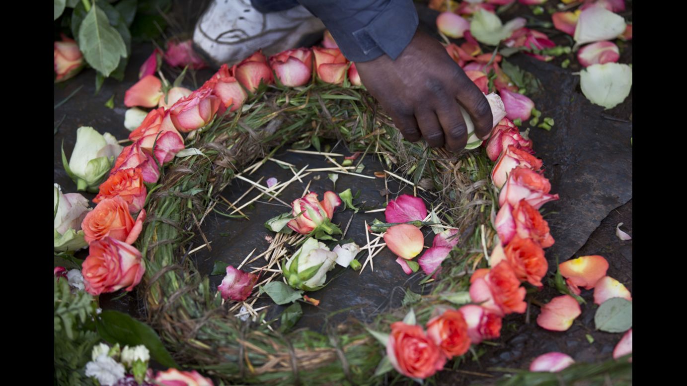 A street vendor makes floral wreaths outside a mortuary in Nairobi on September 25.