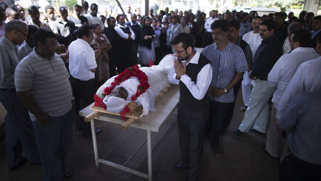 Mourners on Thursday, September 26, observe the body of Sridhar Natarajan, who was killed during the Westgate Shopping Mall attack in Nairobi, Kenya.