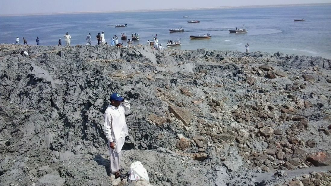 People gather on an island on Wednesday, September 25, that appeared off the coast of Gwadar after the earthquake.