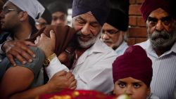 Mourners gather at the Sikh funeral of Dalvinder Kaur Ghataurhae and her grandson Pavraj Singh Ghataurhae, 16, at the Hindi Crematorium in Nairobi on September 25, 2013.